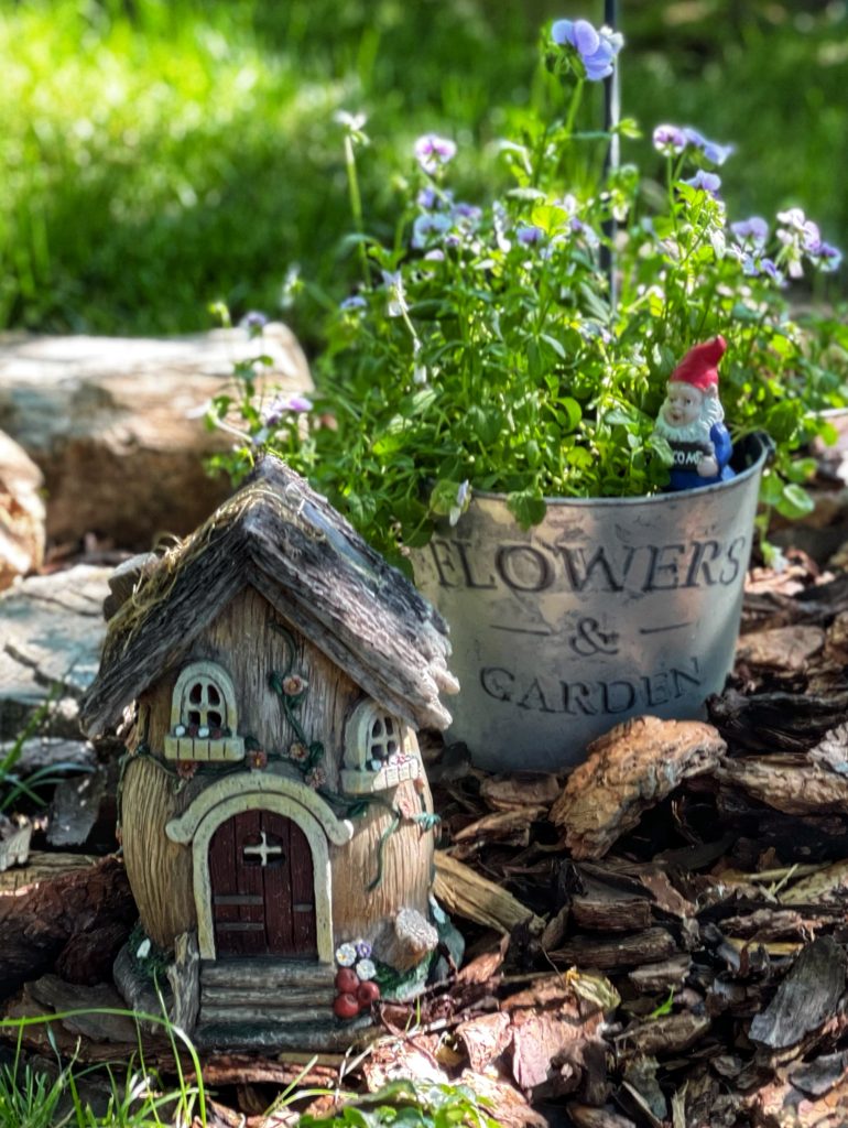 Image of pansies and a fairy house