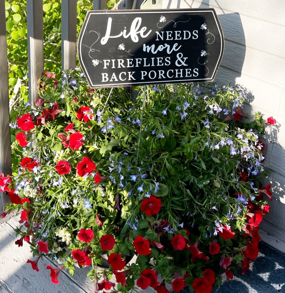 Image of potted flowers with porch sign