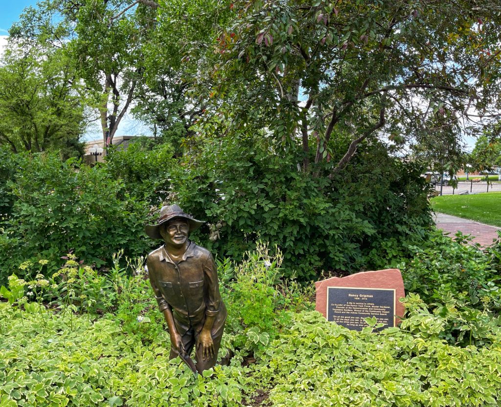 Image of bronze gardener statue in park