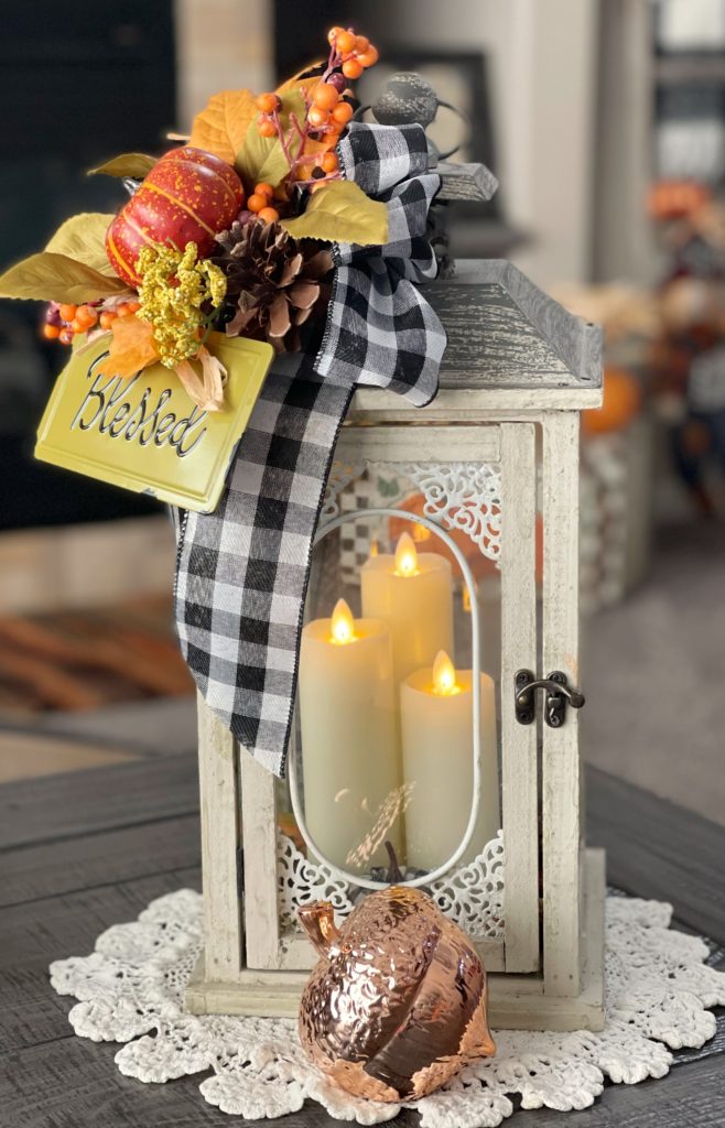 Fall decorated lantern with three candles inside
